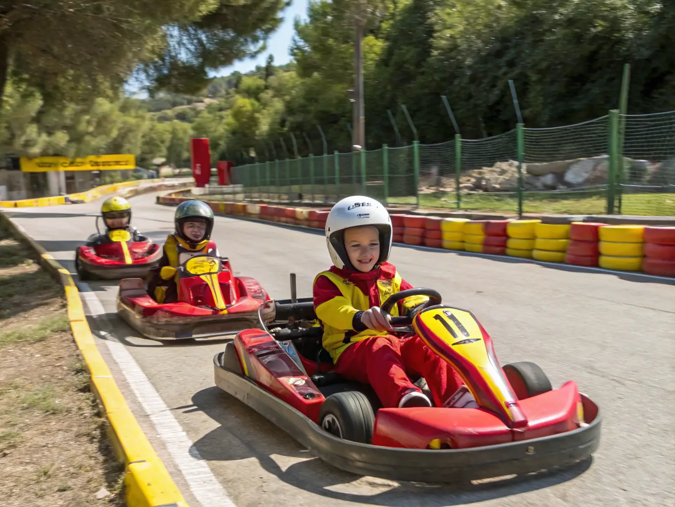 A vibrant image of young participants engaged in a karting session, showcasing the excitement and teamwork involved in the activity. The setting is a well-maintained karting track with safety barriers and professional supervision.