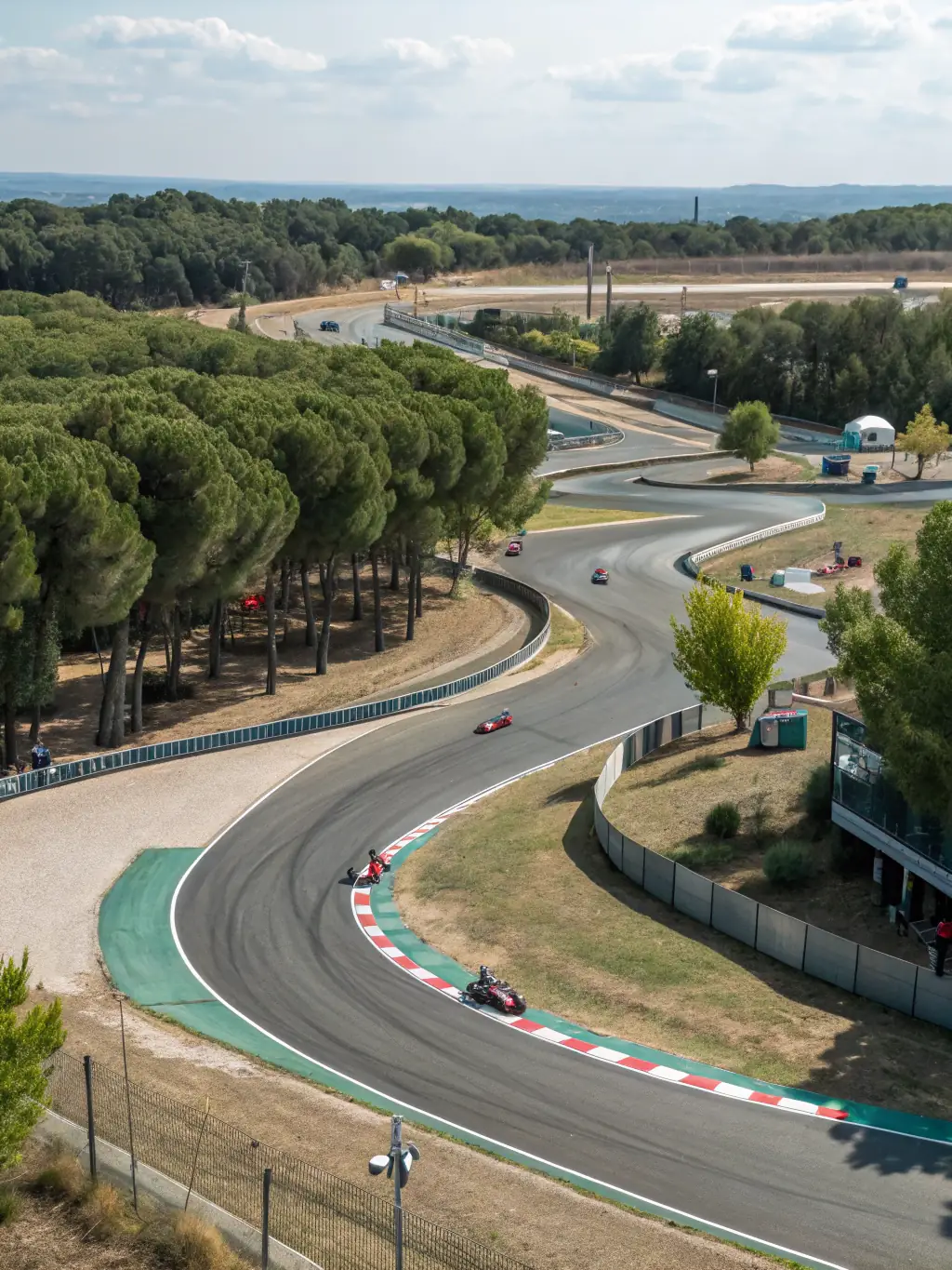 A high-quality image of a modern karting facility with well-maintained tracks and safety barriers, showcasing the professional environment provided by ASSOCIATION TEAM RACING AURILLACOIS.